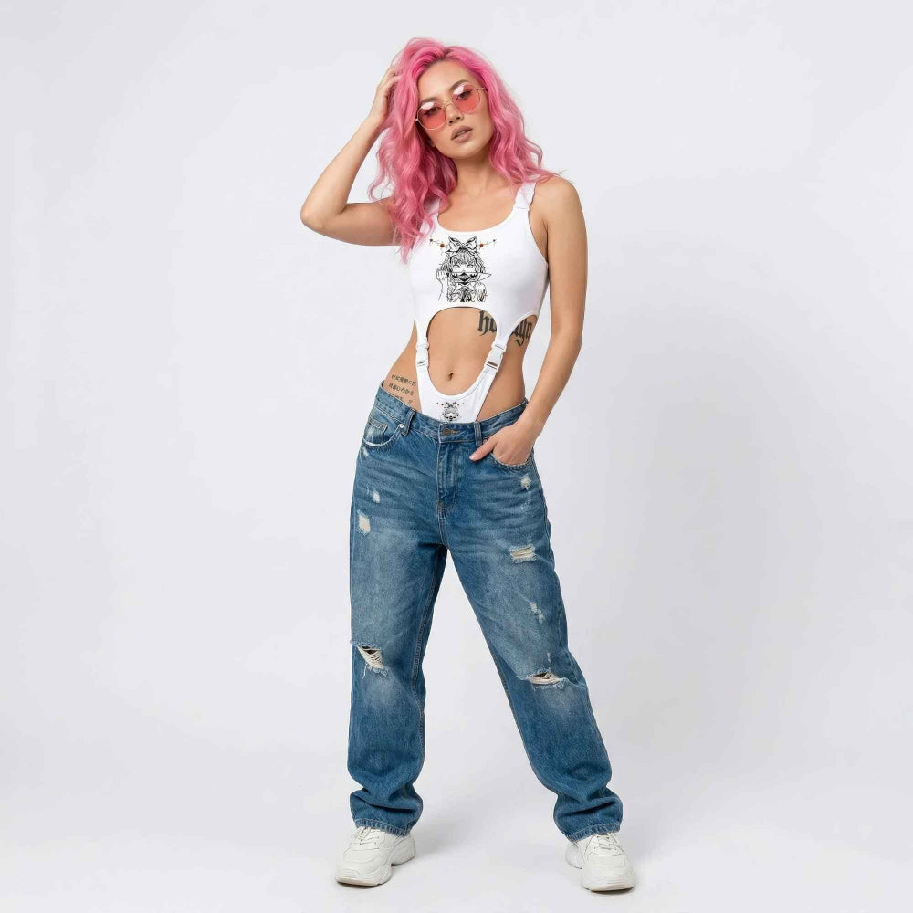 Woman with vibrant pink hair wearing pink-tinted sunglasses and a white sleeveless cut-out bodysuit featuring a graphic print on the chest. Paired with high-waisted distressed blue baggy jeans and white sneakers, she poses confidently with one hand in her hair and the other in her pocket, highlighting visible tattoos.