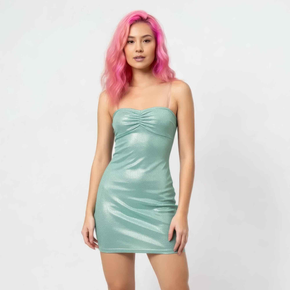 Front view of a woman with vibrant pink wavy hair modeling a shimmering metallic mint green strapless mini dress. The bodycon dress features ruched detailing at the bust and sides for a flattering fit, perfect for a night out or party look.