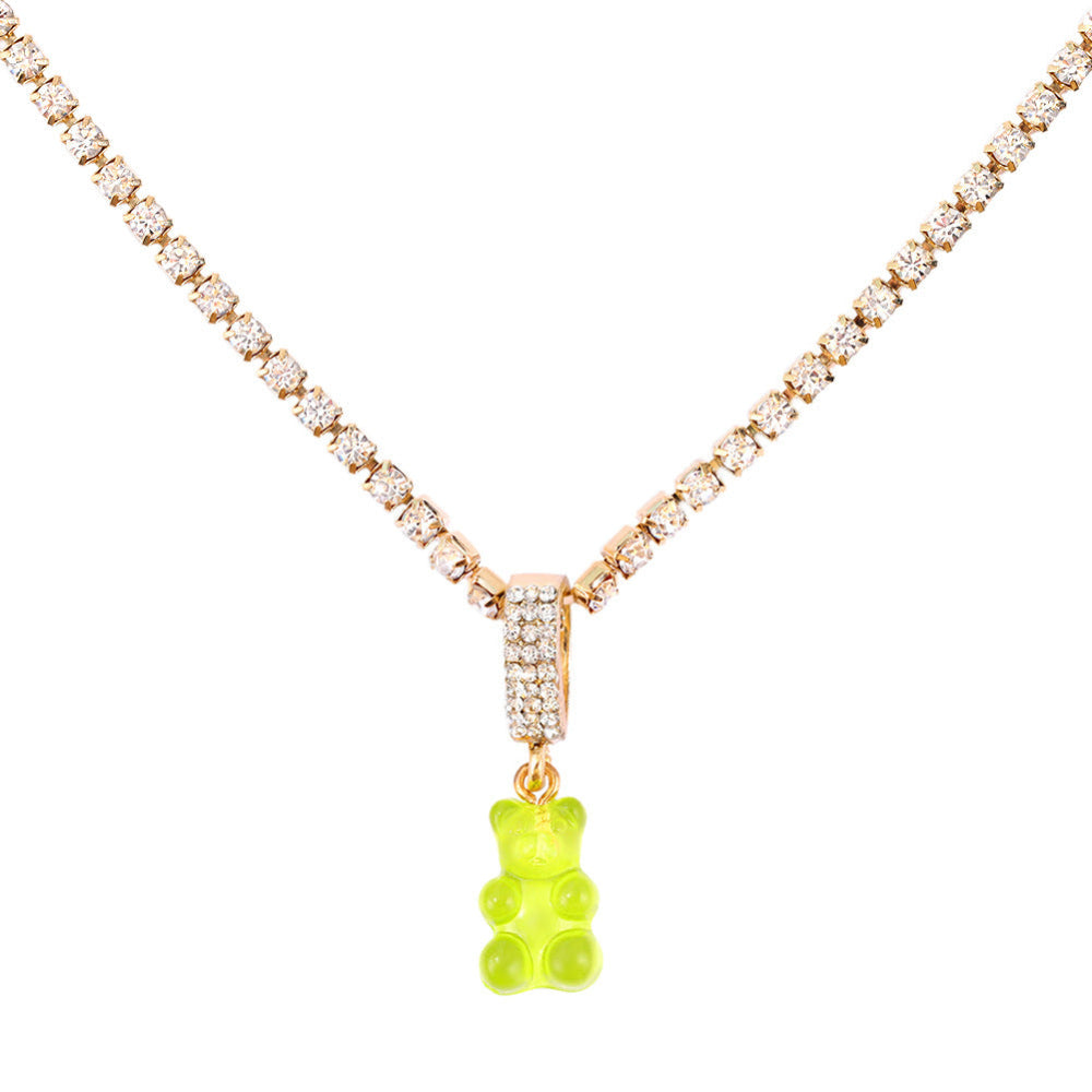 Sparkling silver tennis chain necklace featuring a fully pavé-style band and a bright light green translucent gummy bear pendant hanging from the center. Clean product photography on a plain white background.