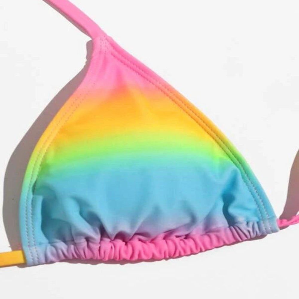 Rainbow ombre triangle bikini top close-up with ruched detail and halter tie straps.