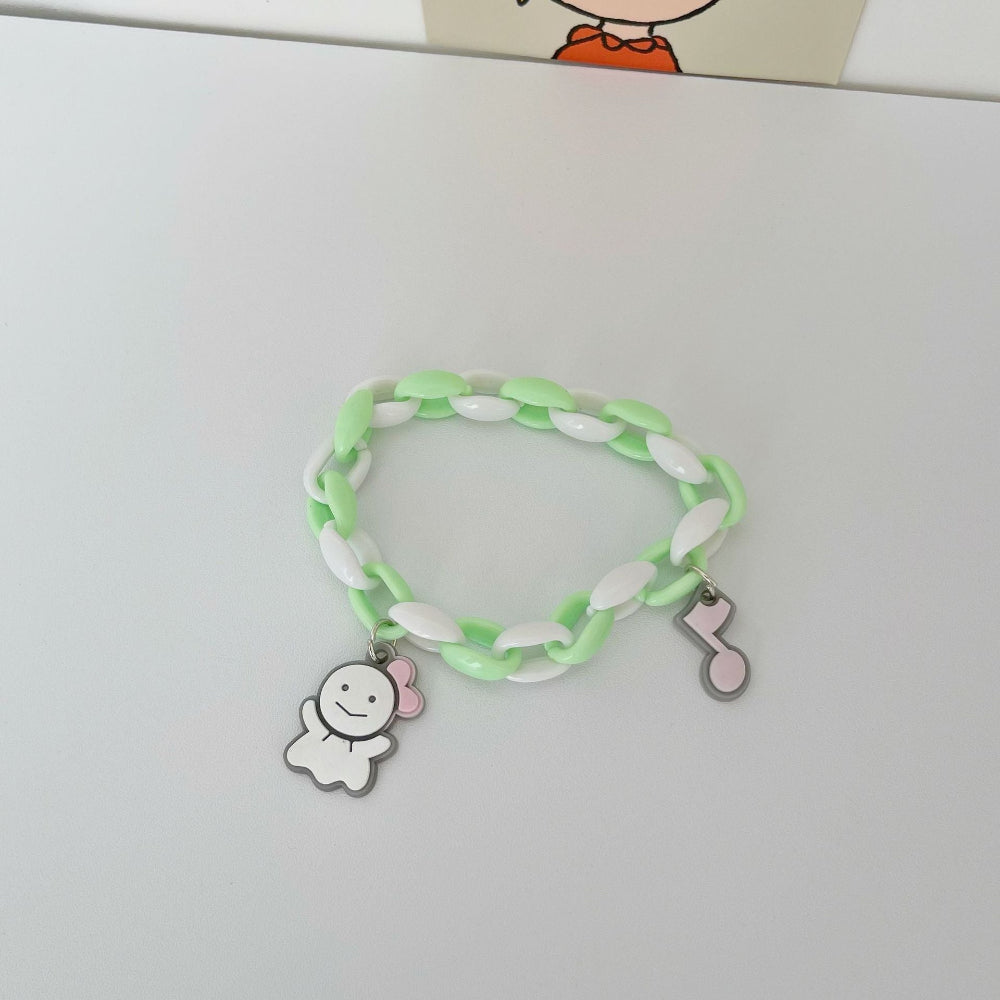 Pastel mint green and white link chain bracelet featuring an adorable white ghost charm with pink bow and a pink musical note charm