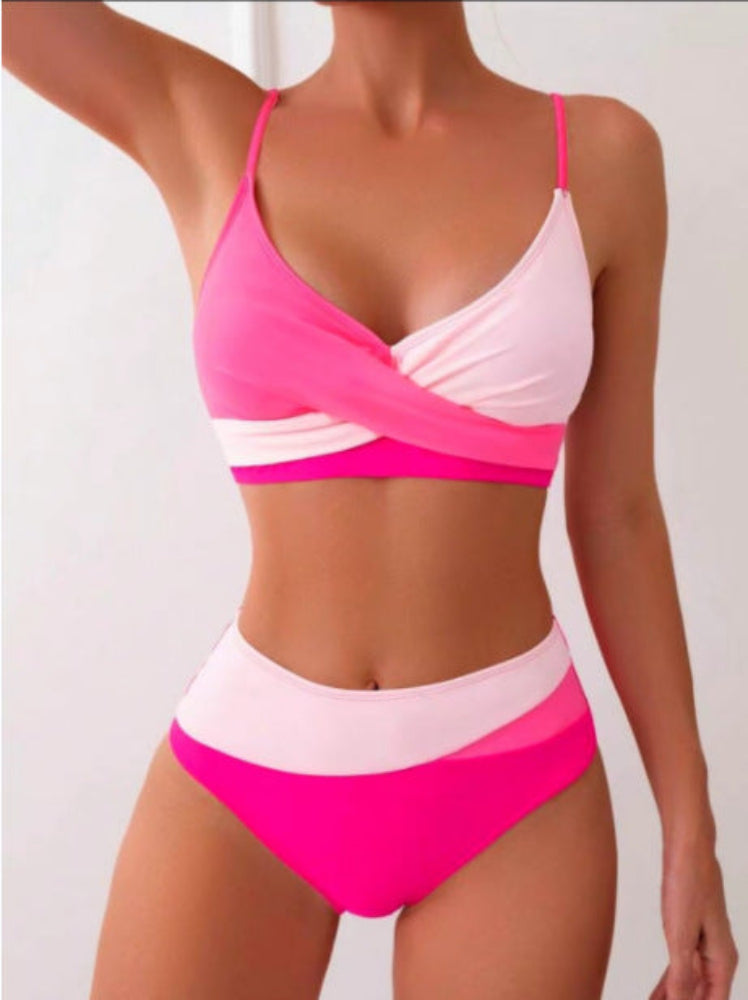 Pink and white bikini set on a plain background
