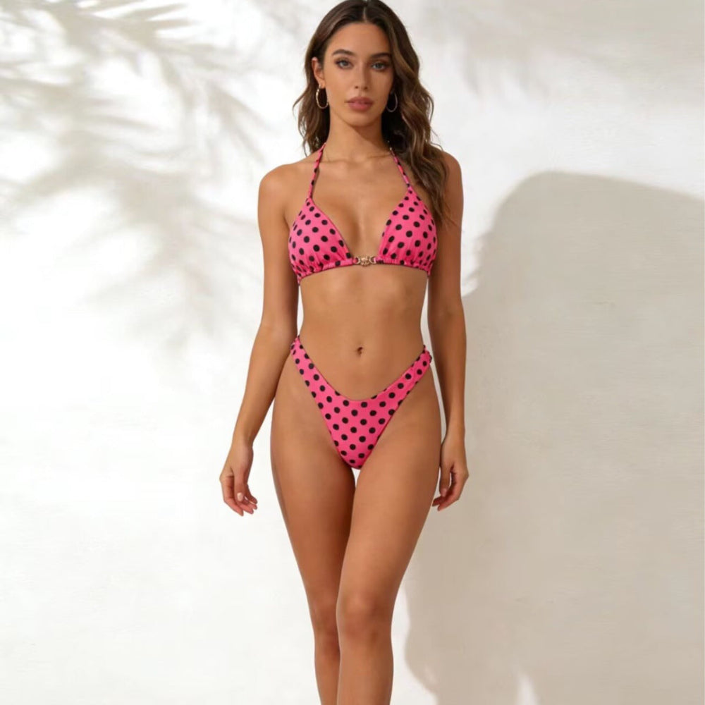 Woman wearing a pink polka dot bikini against a white background