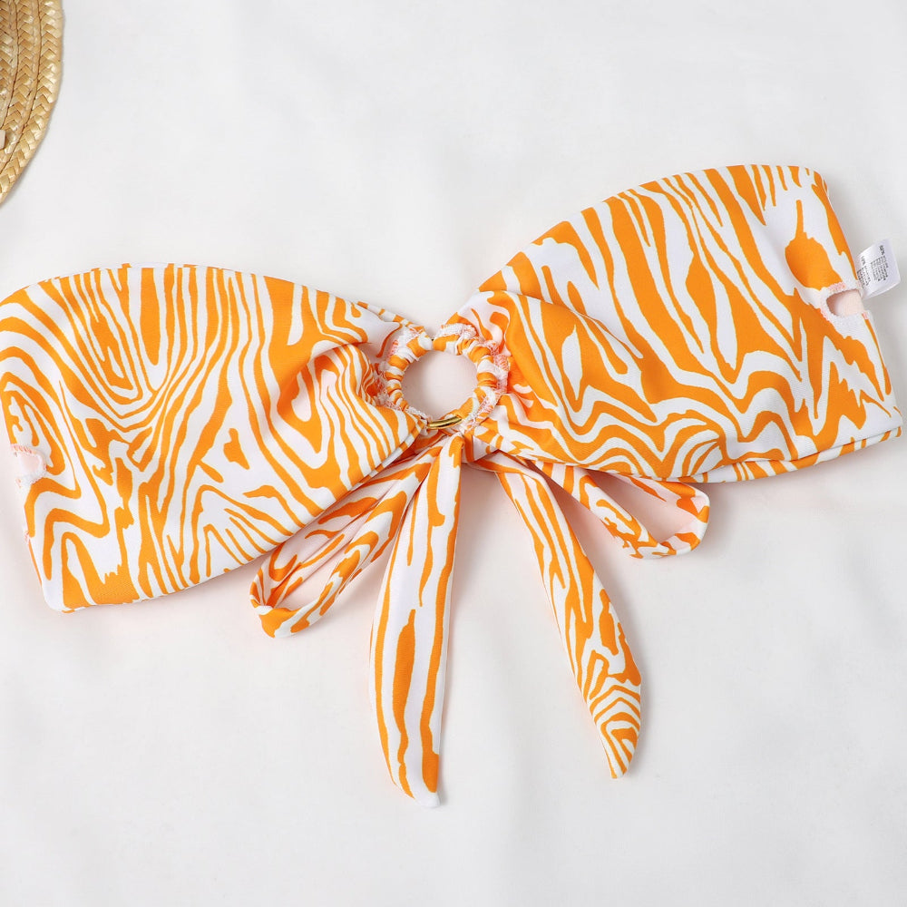 Orange and white patterned bikini top with matching pouch on a white background