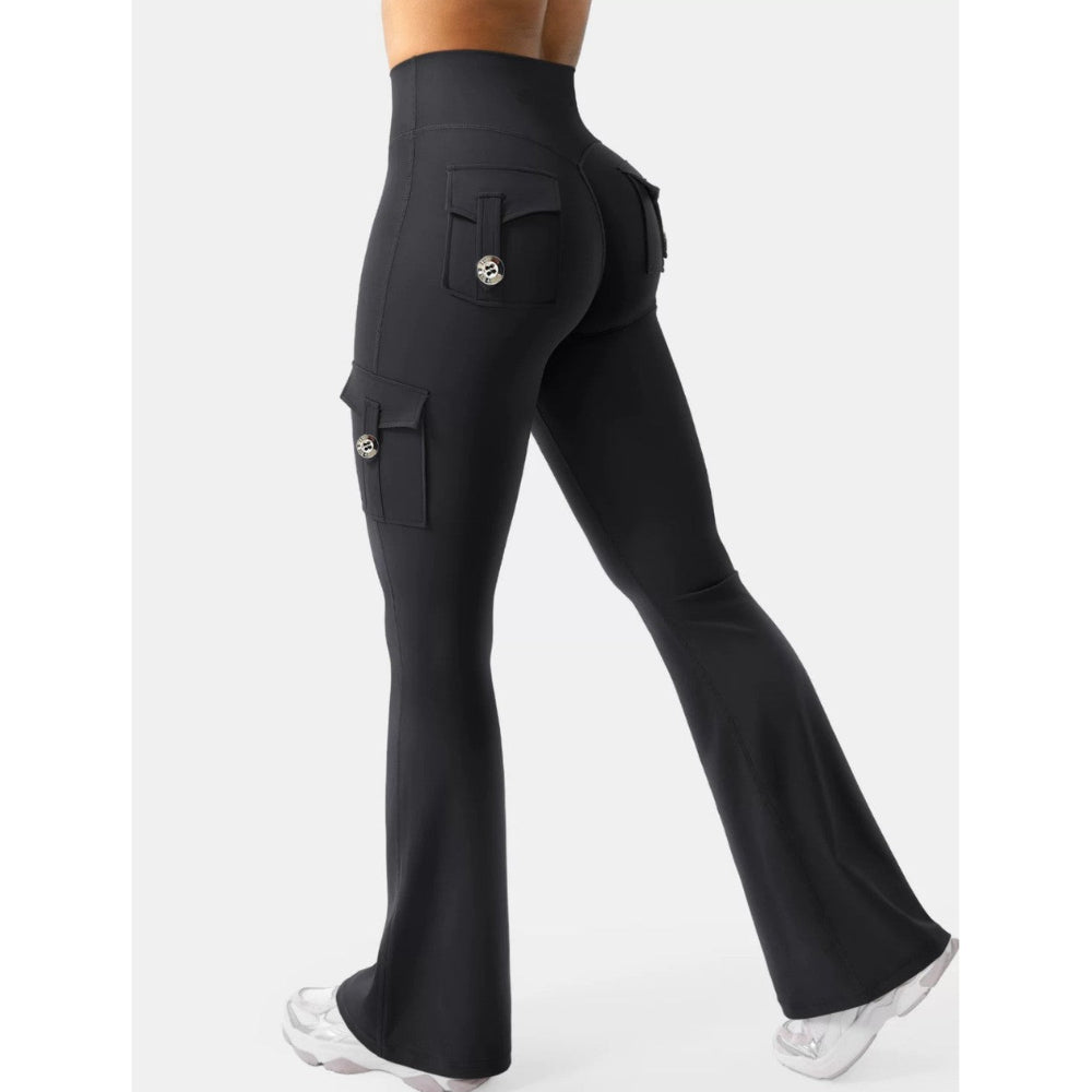 Woman modeling black high-waisted flared cargo pants with side and back pockets, shown from a rear three-quarter view against a clean white studio background.
