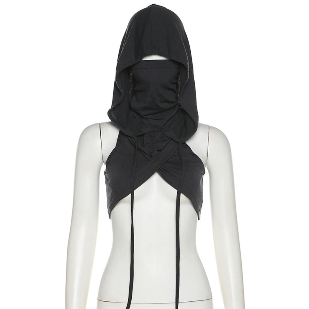 Black hooded crop top on a mannequin with a full head-covering balaclava-style hood, face opening, draped and twisted fabric at the chest, and long adjustable ties hanging down the front.