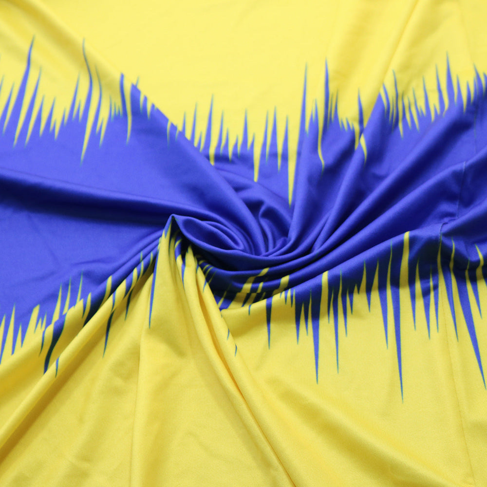 Close-up of blue and yellow fabric with a swirling pattern