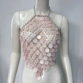 Mannequin wearing a luxurious pale pink sequin halter top featuring cascading iridescent circular sequins, silver chain straps, and delicate bead accents. The statement piece has a flowing, layered design with sparkling details.