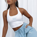 White ribbed halter crop top with "made in heaven" printed text, paired with matching light blue sweatpants, worn by a model.
