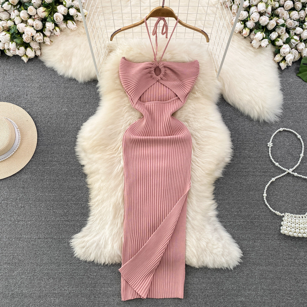 Dusty pink ribbed knit halter maxi dress with front keyhole cutout on wooden hanger.