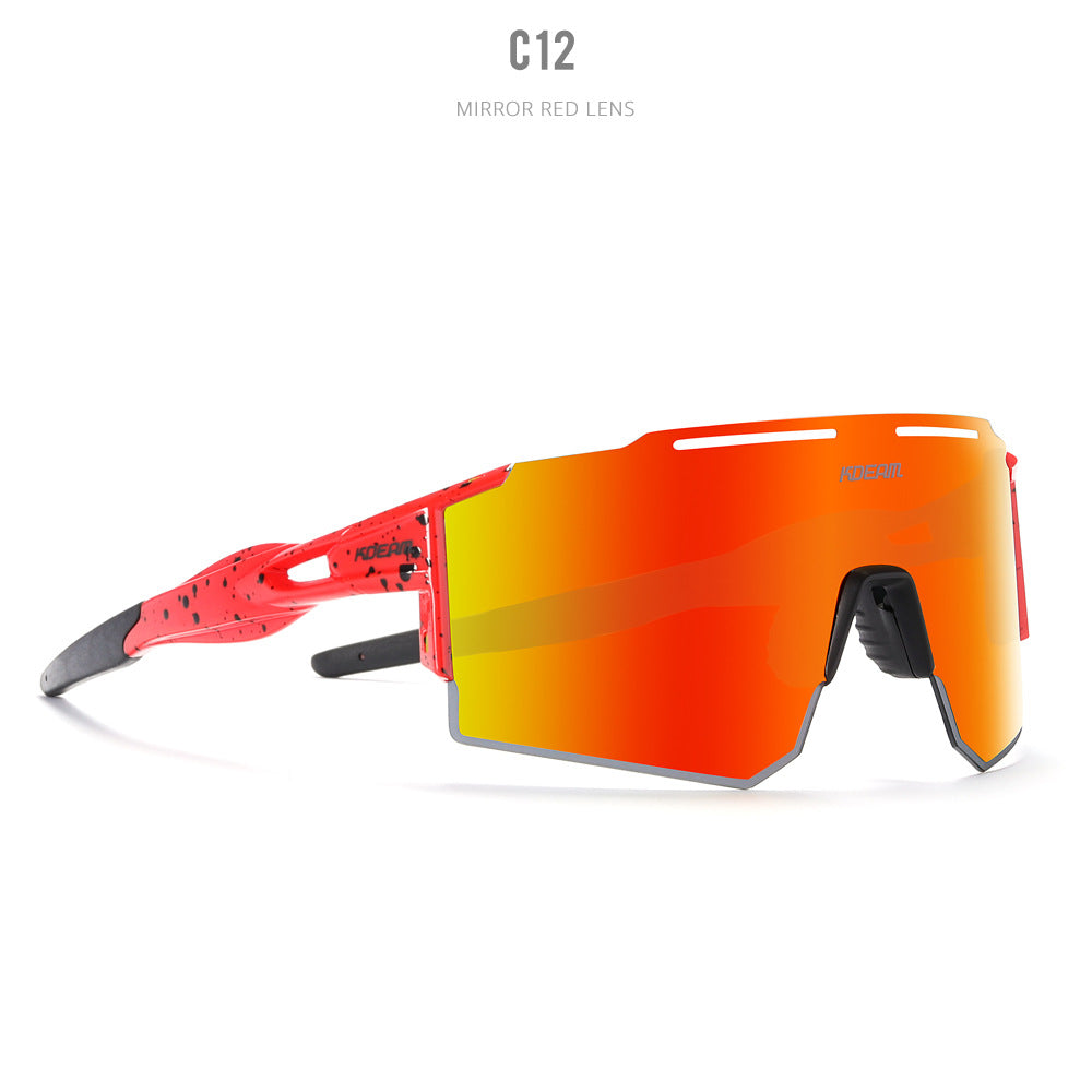 Vibrant red performance sport sunglasses with black speckled accents featuring a large orange-to-red iridescent mirrored shield lens and futuristic design