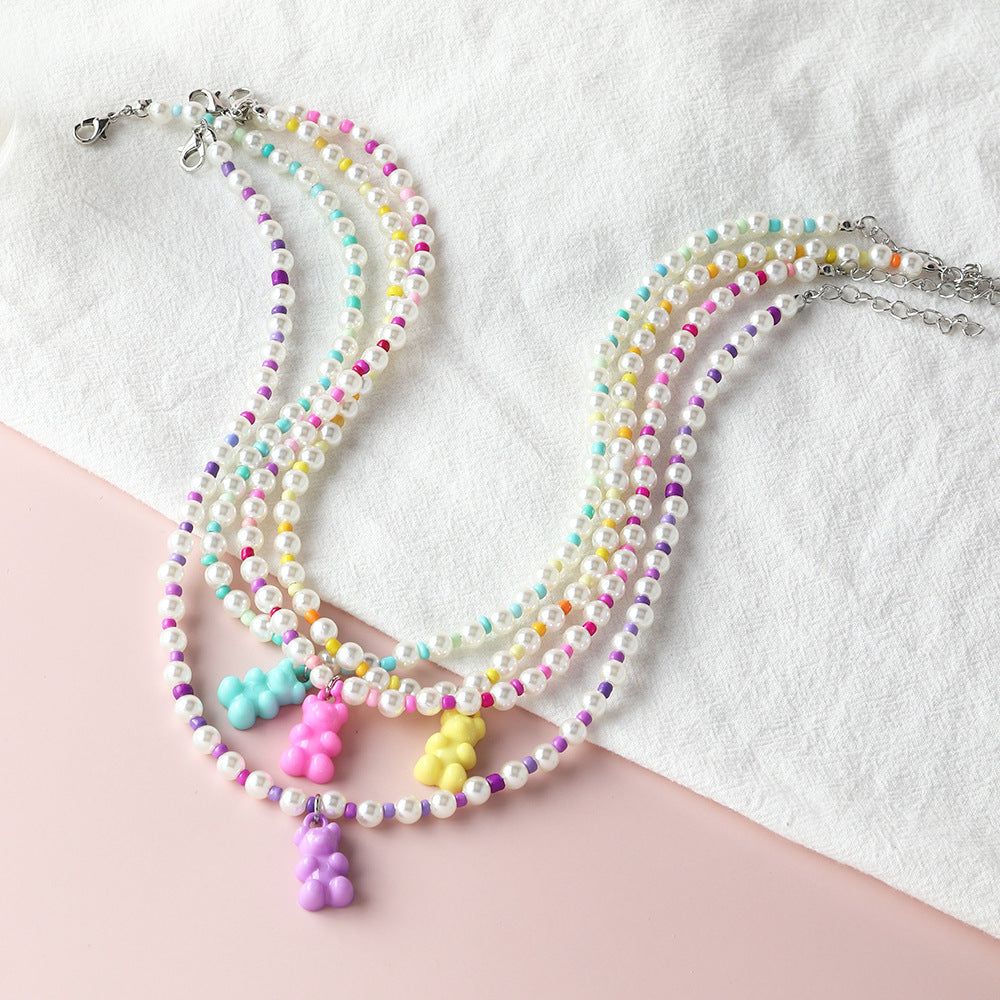 Colorful pearl beaded gummy bear necklaces – trendy pastel multi-color charm necklaces with bear pendants, product flat lay.