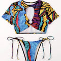 Colorful abstract-patterned crop top and bikini bottom set on a white background