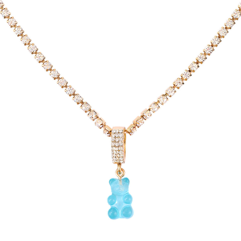 Sparkling silver tennis chain necklace featuring a fully pavé-style band and a bright sky blue translucent gummy bear pendant hanging from the center. Clean product photography on a plain white background.