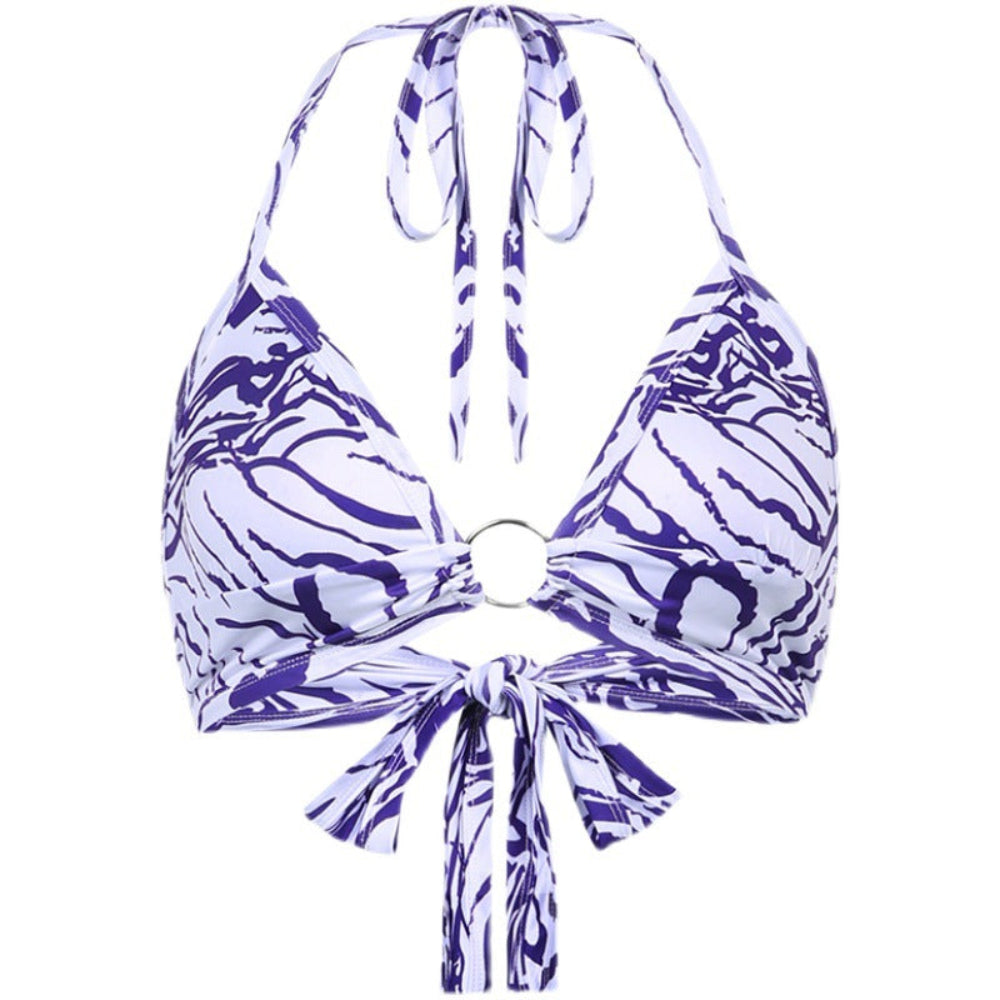 Purple and white patterned bikini top on a white background