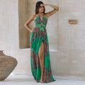 Leopard print green maxi dress on model – trendy animal print color-block long dress with slit and halter neck, stone wall outdoor setting.