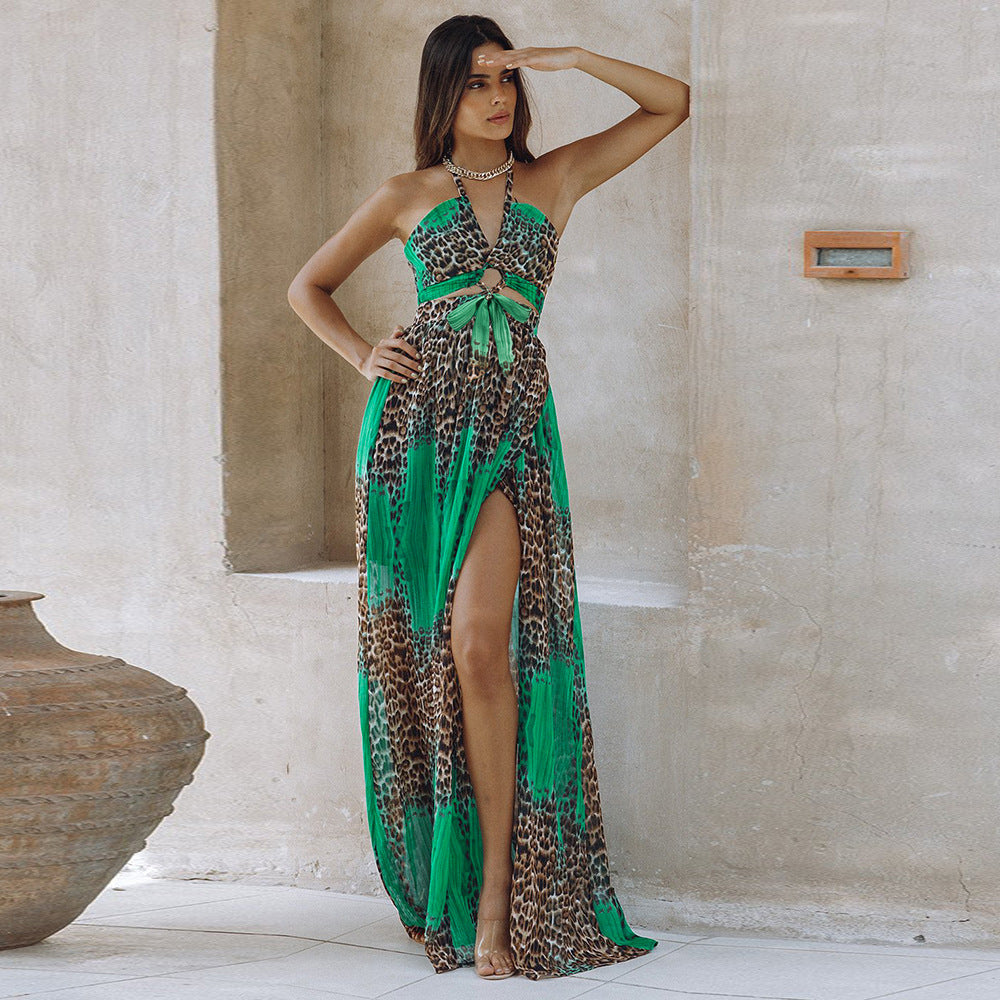 Leopard print green maxi dress on model – trendy animal print color-block long dress with slit and halter neck, stone wall outdoor setting.
